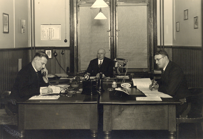 881939 Afbeelding van een kamer van het Inspectiebureau N.S. te Utrecht (?), met links dhr. Koolen en in het midden ...